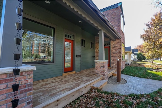 view of exterior entry with a porch