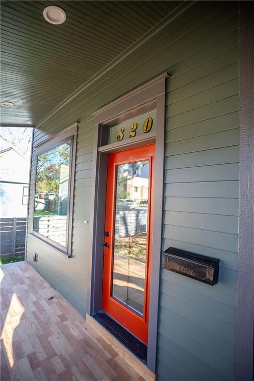 view of exterior entry with covered porch