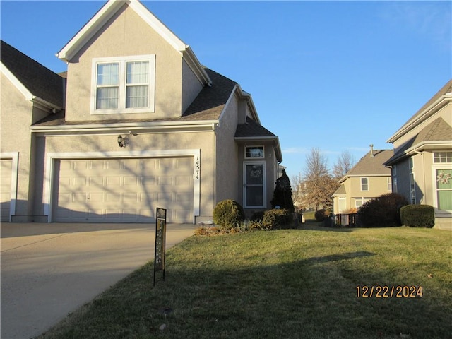 view of front of property featuring a garage and a front yard