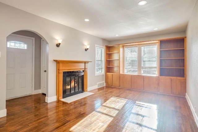 unfurnished living room featuring dark hardwood / wood-style flooring