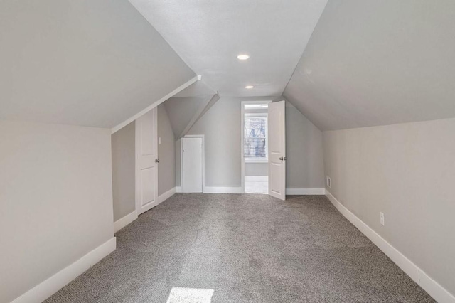 additional living space featuring carpet and lofted ceiling