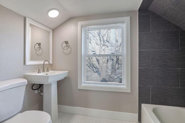 bathroom featuring tile patterned flooring, toilet, lofted ceiling, and shower with separate bathtub