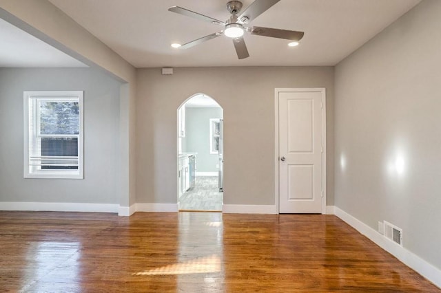 unfurnished room with ceiling fan and hardwood / wood-style flooring