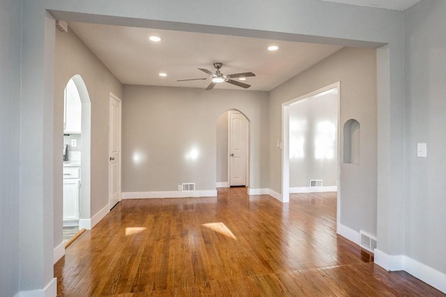 empty room with ceiling fan and wood-type flooring