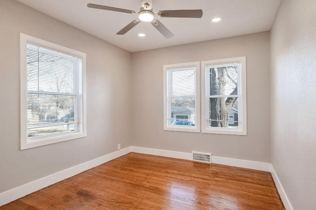 empty room featuring ceiling fan and hardwood / wood-style flooring