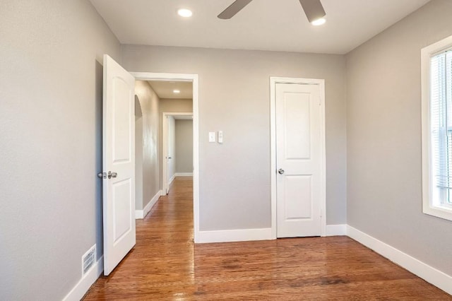 unfurnished bedroom with hardwood / wood-style floors and ceiling fan