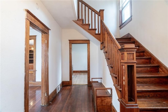 staircase featuring wood-type flooring