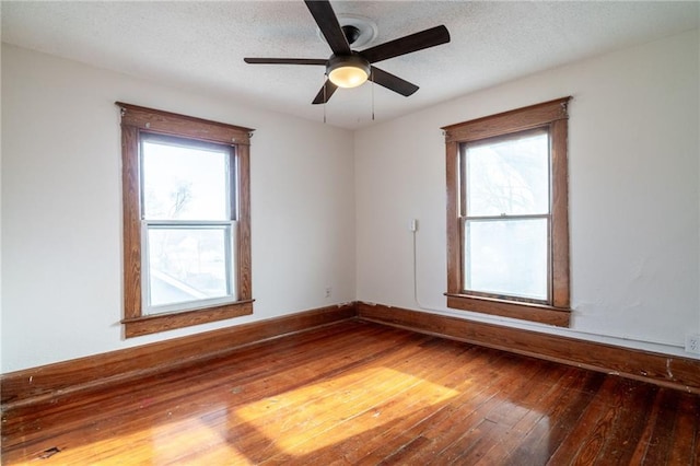 spare room with hardwood / wood-style flooring, ceiling fan, and a textured ceiling