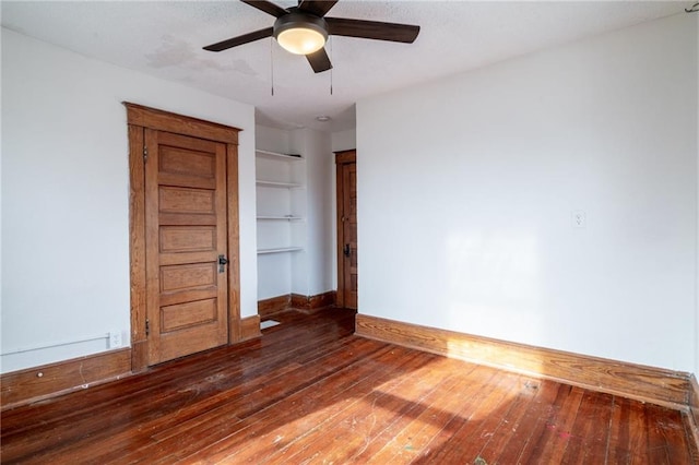 unfurnished room with ceiling fan and dark hardwood / wood-style flooring