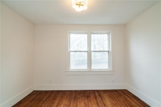 empty room with dark hardwood / wood-style floors