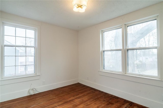 spare room featuring dark hardwood / wood-style flooring