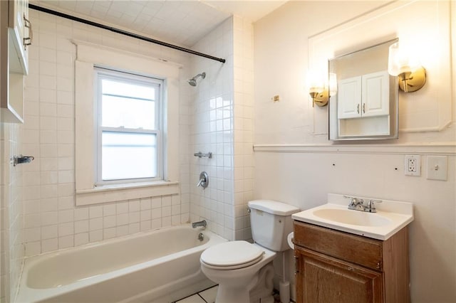 full bathroom with tile patterned floors, vanity, tiled shower / bath combo, and toilet