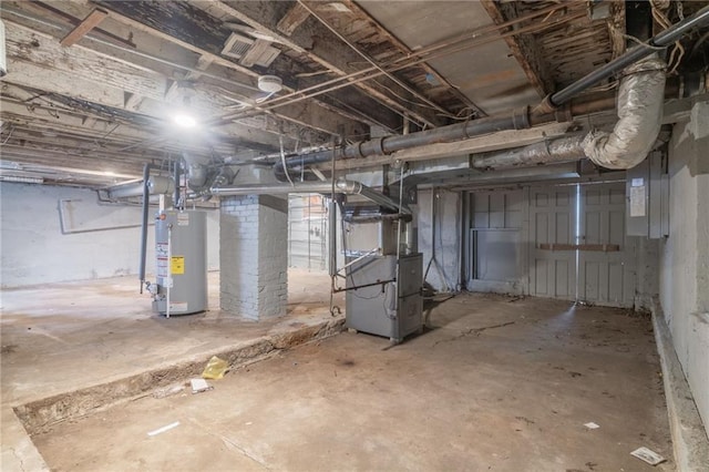 basement featuring electric panel, water heater, and heating unit