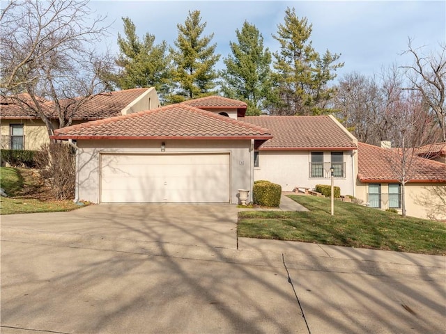 mediterranean / spanish-style house with a garage and a front lawn