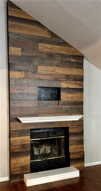 interior details featuring wooden walls and wood-type flooring