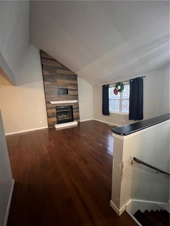 living room with dark hardwood / wood-style floors and lofted ceiling