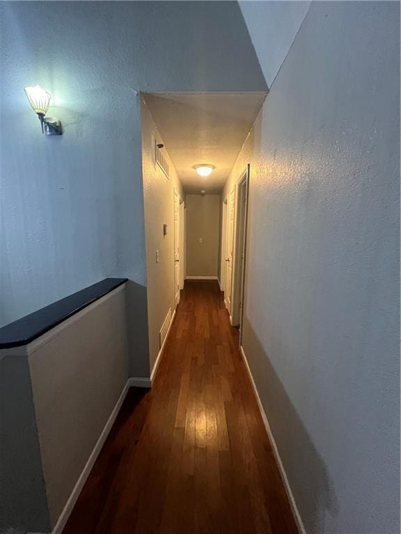 hallway featuring dark hardwood / wood-style floors