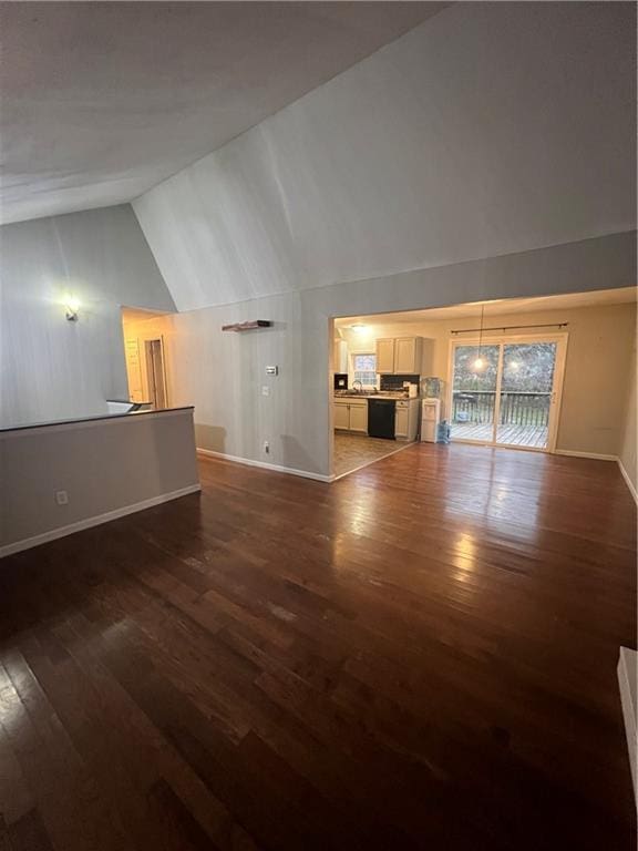 unfurnished living room with dark hardwood / wood-style flooring and lofted ceiling