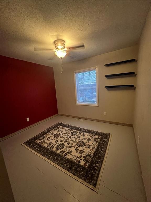 empty room featuring a textured ceiling and ceiling fan