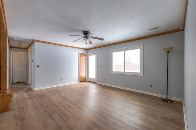 empty room featuring hardwood / wood-style floors, ceiling fan, and crown molding