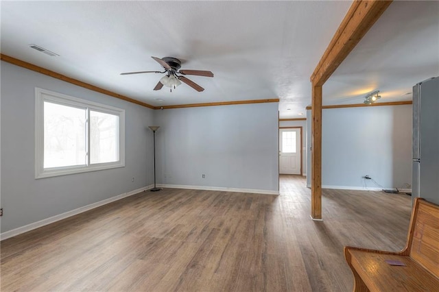 empty room with ceiling fan, light hardwood / wood-style floors, and ornamental molding