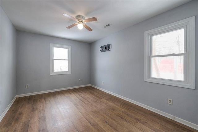 empty room with hardwood / wood-style flooring and ceiling fan