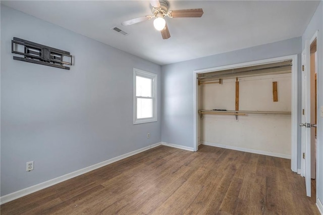 unfurnished bedroom featuring ceiling fan, a closet, and wood-type flooring