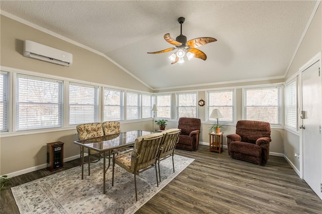 sunroom with vaulted ceiling, an AC wall unit, and ceiling fan