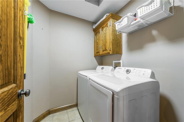 laundry area featuring cabinets and separate washer and dryer