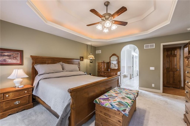 carpeted bedroom featuring ceiling fan and a raised ceiling