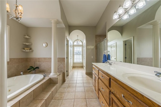 bathroom with decorative columns, vanity, independent shower and bath, tile patterned flooring, and a chandelier