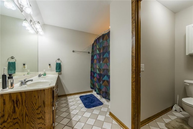 bathroom featuring tile patterned flooring, vanity, toilet, and curtained shower