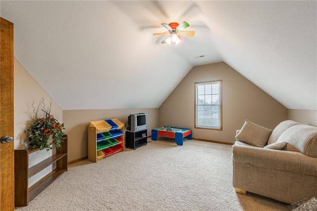 rec room featuring ceiling fan, carpet, and vaulted ceiling