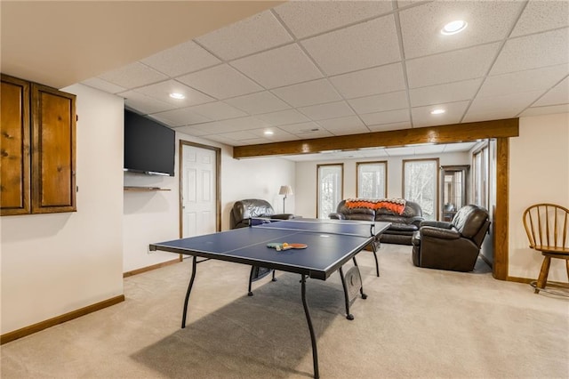 recreation room with light colored carpet and a drop ceiling