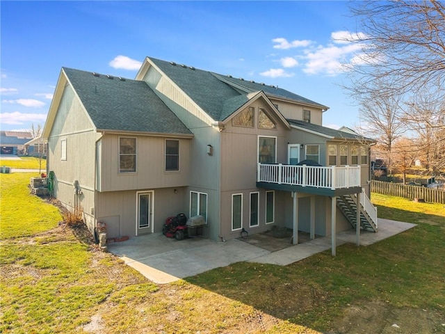 back of property with a lawn, a patio, and a deck