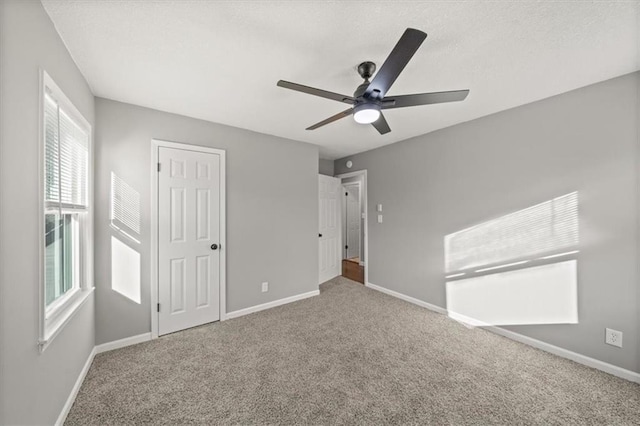 unfurnished bedroom with carpet floors and ceiling fan