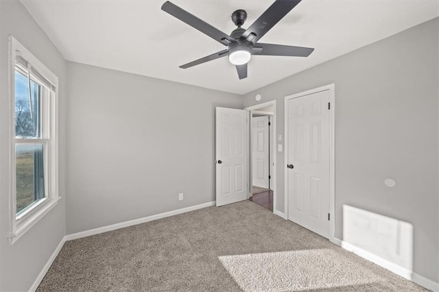 unfurnished bedroom featuring ceiling fan and carpet floors