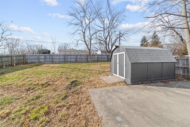 view of yard with a storage shed and a patio area