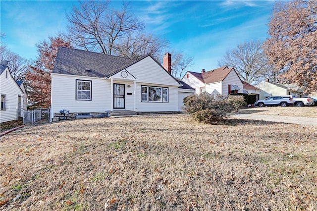 bungalow-style home with a front yard