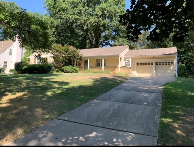 ranch-style house featuring a garage and a front lawn