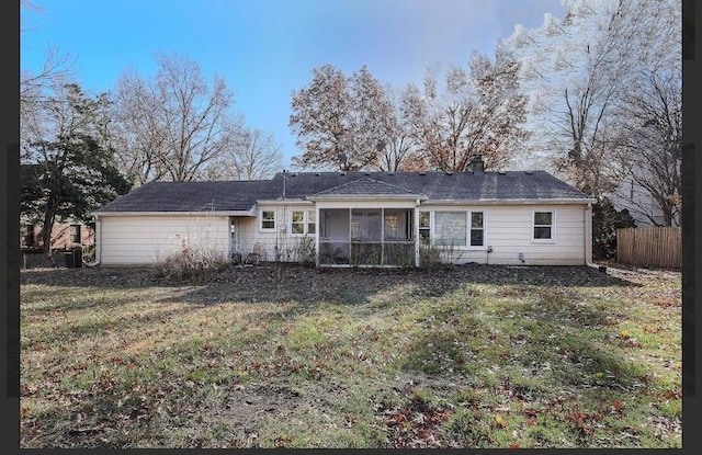 back of house featuring a sunroom and a yard