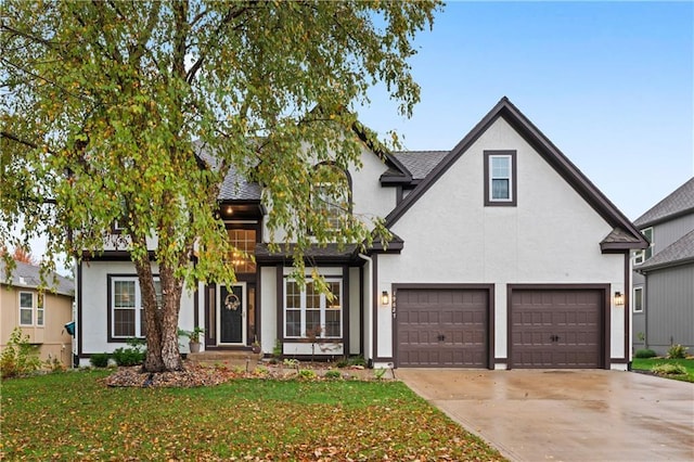 view of front of house featuring a garage and a front lawn