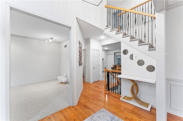 interior space with hardwood / wood-style flooring and crown molding