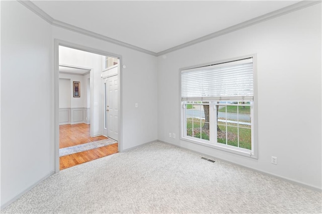 unfurnished room featuring carpet and ornamental molding