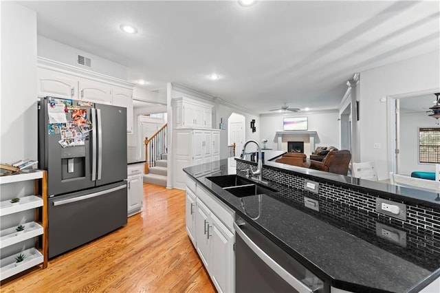 kitchen featuring white cabinets, appliances with stainless steel finishes, ceiling fan, and sink