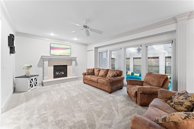 living room featuring ceiling fan, crown molding, and light carpet