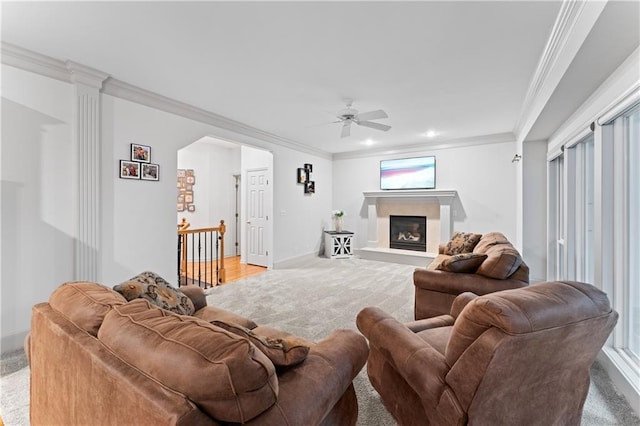 living room featuring ceiling fan, carpet floors, and ornamental molding