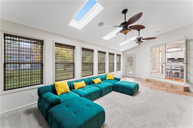 living room with ceiling fan, lofted ceiling with skylight, and carpet floors