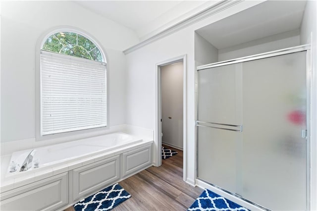 bathroom featuring hardwood / wood-style flooring and separate shower and tub