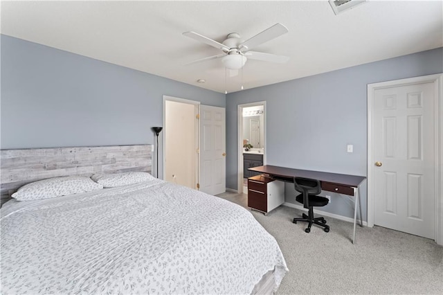 bedroom with ensuite bath, ceiling fan, and light carpet